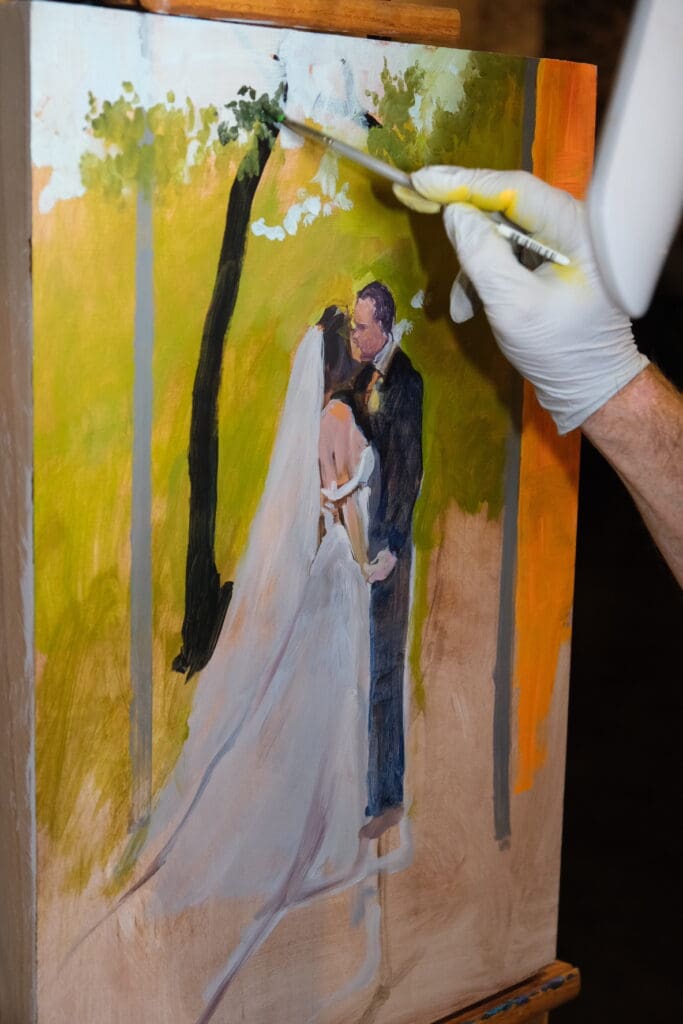 up close photo of live wedding painter Charles Ingram starting a live wedding painting at wedding venue Park 31