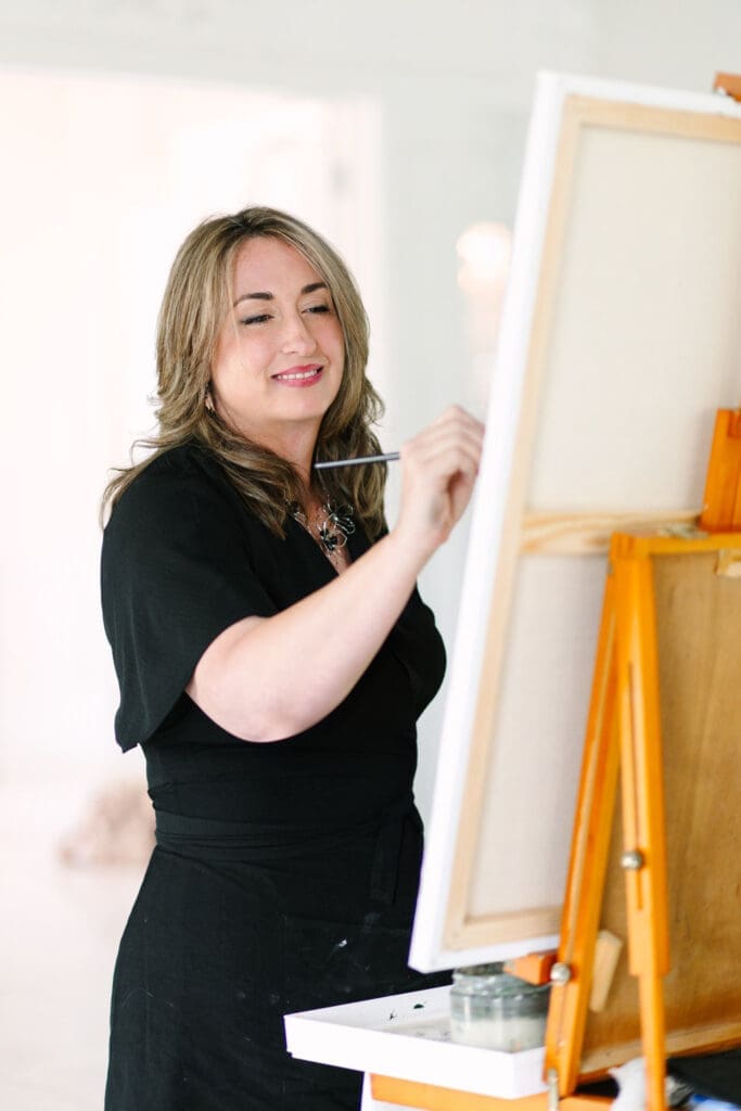 Luxury live wedding painter Laura Herndon creating custom artwork at a high-end Austin wedding reception