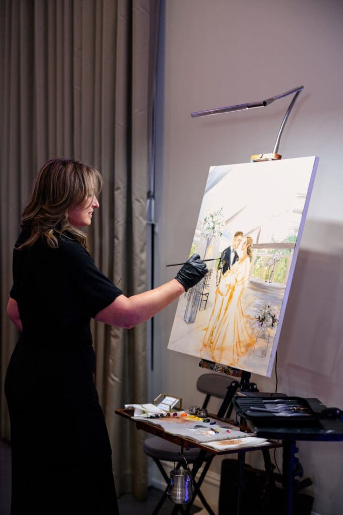 Luxury wedding painter creates a custom wedding painting for the bride and groom in Tomball Texas at the historic Sandlewood Manor