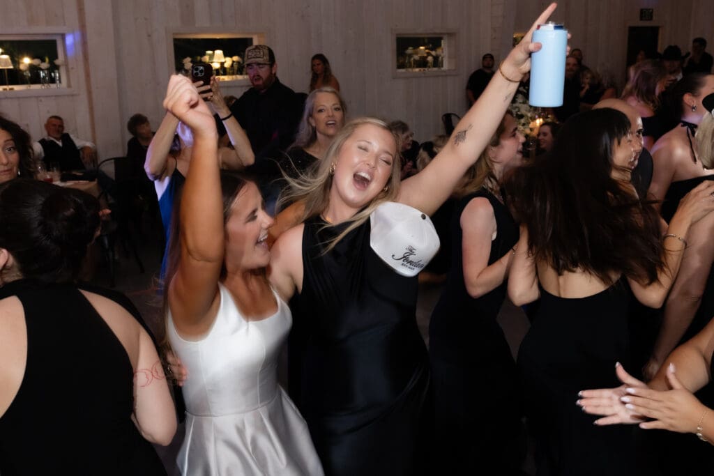 A bride and her friends party on the dance floor.
