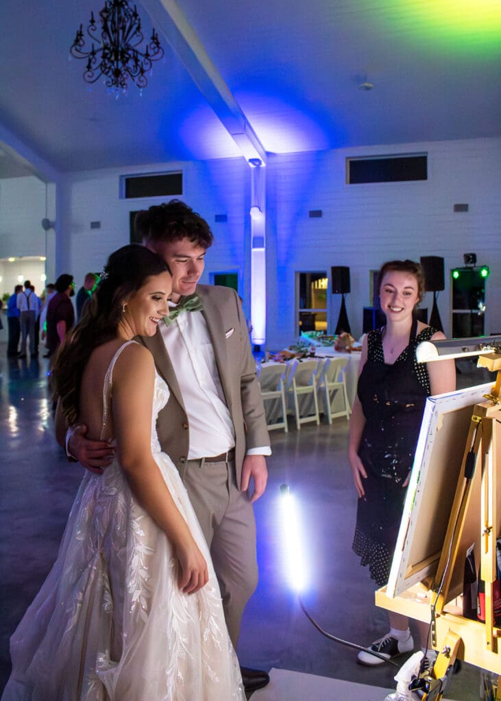The live wedding painting is revealed at the end of the reception.