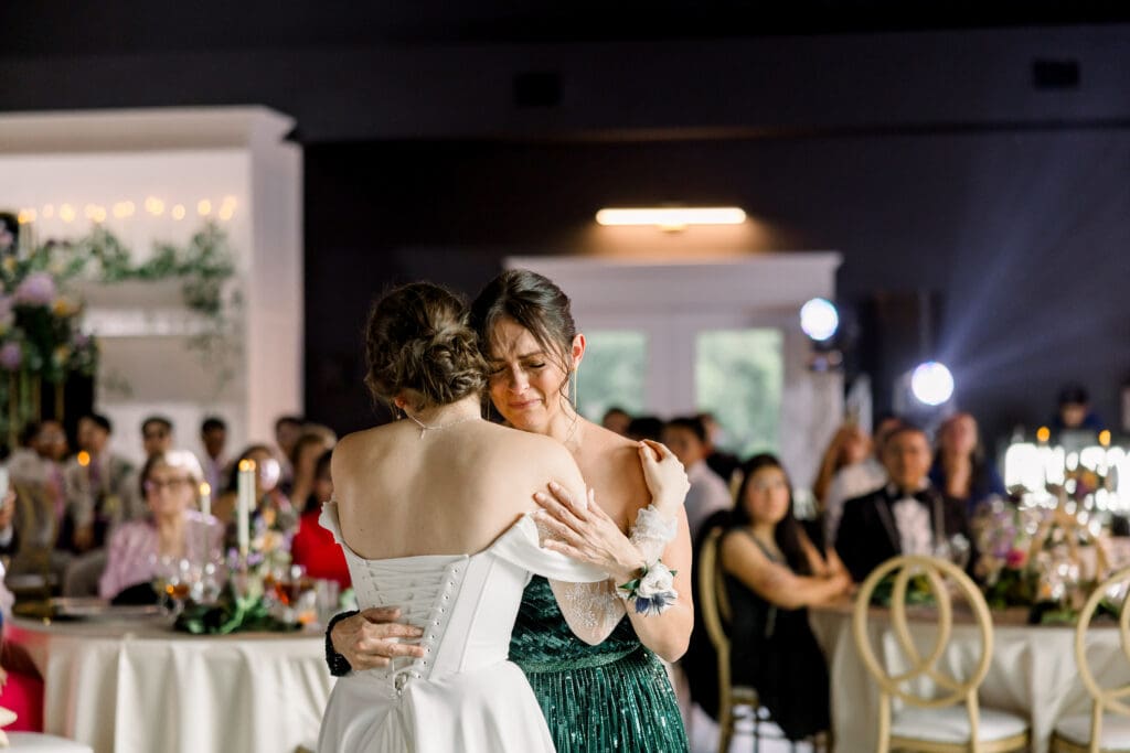 Tears are shed when bride surprises her mom with a special mother-daughter wedding dance.